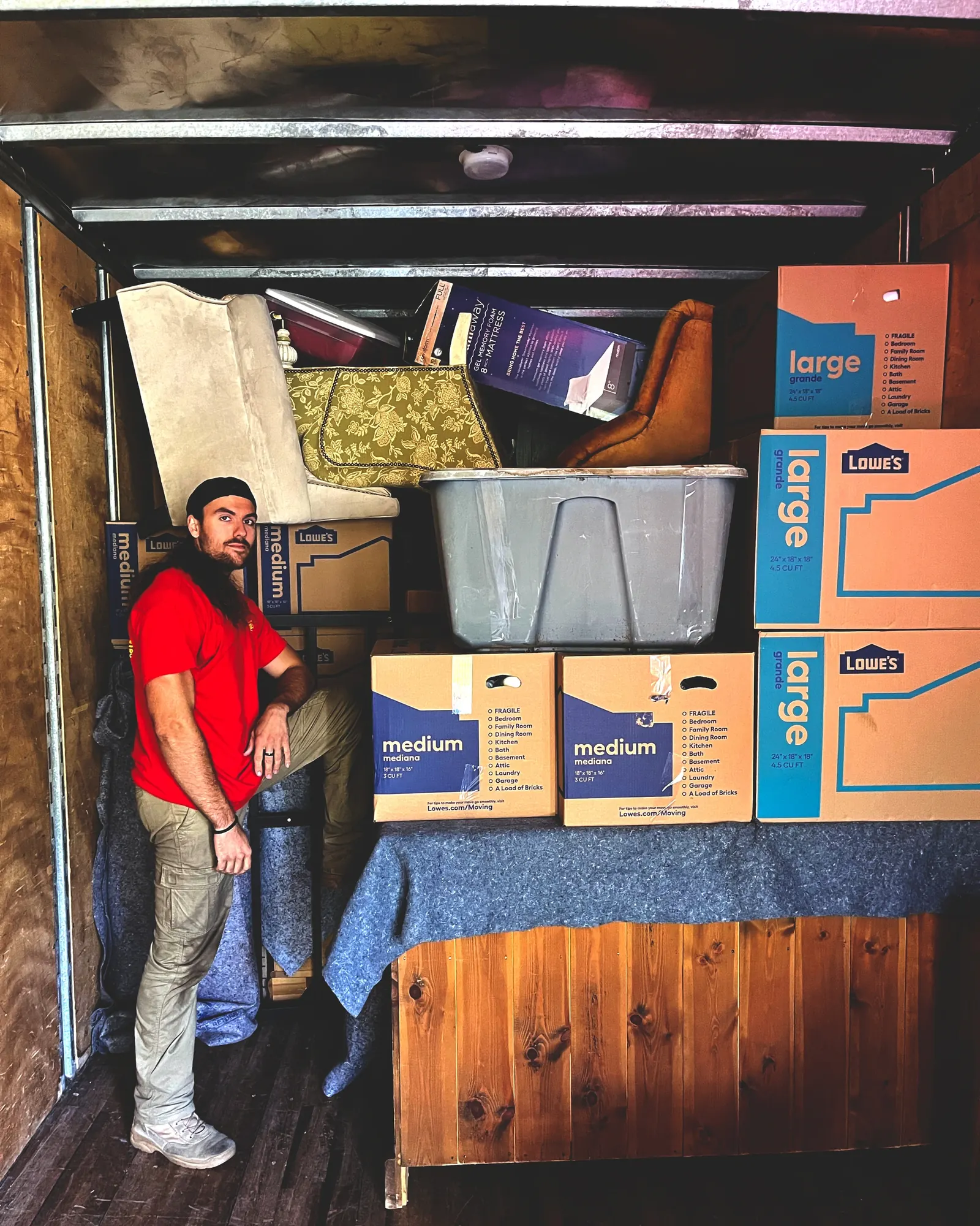 Sunrise Moving and Packing crew member standing near a truck